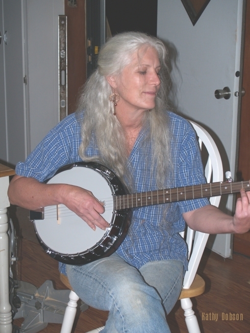 Banjo Musician Entertain Constrution Help others Economic Stimulus Recovery work with neighbors help others photograph of Colette Dowell playing Banjo at Kathy D's home